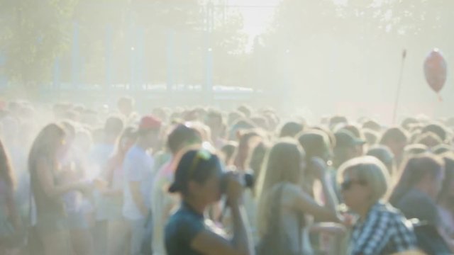 4k clip of dancing crowd on Holi Festival Of Colors. Colored dust.