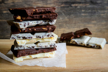 chocolate bar stack on wooden background.