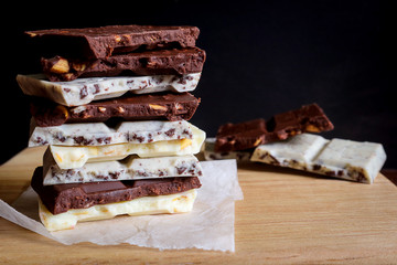 chocolate bar stack on wooden background.