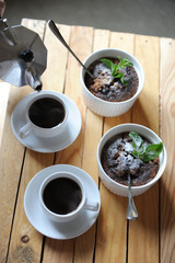 Dessert healthy breakfast of oat pudding in a white keraimic mold. Moka coffee in white cups