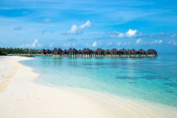 beach with water bungalows at Maldives