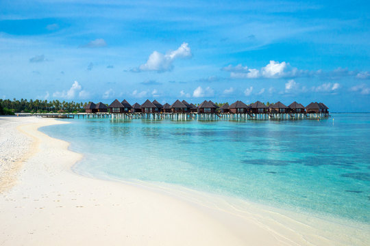 beach with water bungalows at Maldives