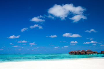 beach with water bungalows at Maldives