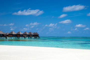 beach with water bungalows at Maldives