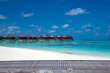 beach with water bungalows at Maldives