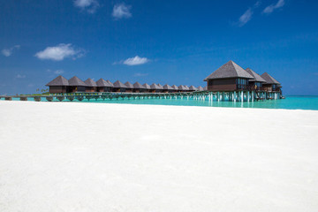 beach with water bungalows at Maldives