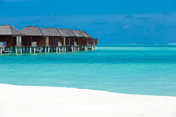 beach with water bungalows at Maldives