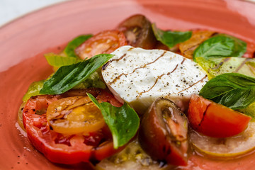 Caprese salad Tomato and mozzarella slices with basil