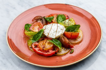 Caprese salad Tomato and mozzarella slices with basil