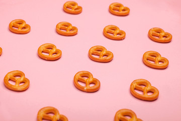 Fototapeta premium many PRETZELS bakery on pink background, selective focus photo