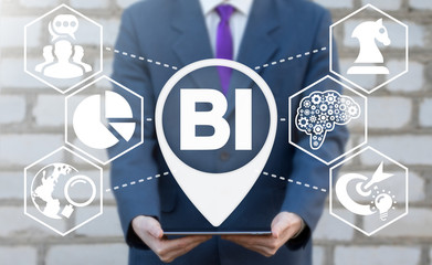 Business Intelligence concept. Man holds tablet computer with BI location icon on virtual screen.