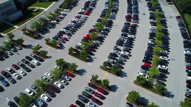 Aerial drone video cars in a parking lot pov