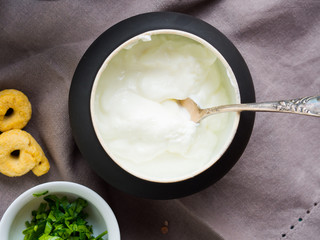 Bowl of sour cream or yogurt dip on gray napkin