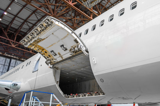 Luggage compartment and cargo section in the airplane open on inspection