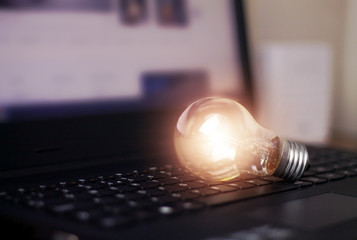 Light bulb on keyboard laptop.
