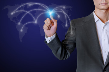 Business man touch social network structure of Digital composite on light  of Midsection with globe background. Selective focus on the finger.
