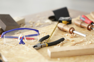 Table with tools in carpenter's workshop, closeup