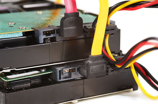 Two harddrives with power and data cables, closeup.