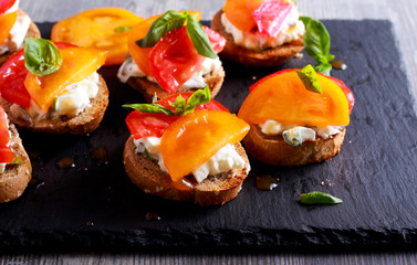 Cheese and basil tomato topped bruschetta