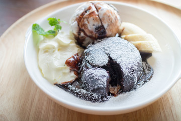 hot chocolate lava cake with vanilla ice cream ball, banana and whipped cream
