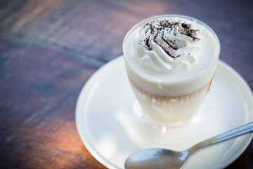 Delicious milk pudding with grated chocolate over napkin on wood table
