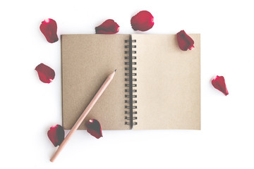 Red rose with petals and brown notebook for valentine background isolated on white background