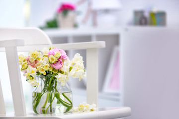 Beautiful bouquet with white freesia flowers on table at home