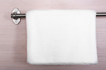 Clean white towel on hanger in bathroom