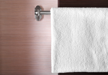 Clean white towel on hanger in bathroom