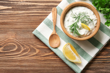 Delicious yogurt sauce with fennel in bowl on kitchen table
