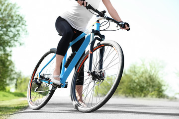 Fototapeta na wymiar Sporty female cyclist with bicycle outdoors on sunny day