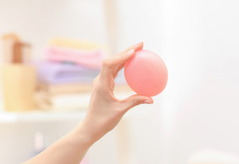 Hand of woman with soap in bathroom