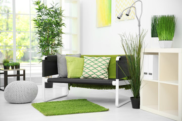 Comfortable living room in white color with green decoration