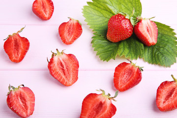 Fresh strawberries on pink wooden table
