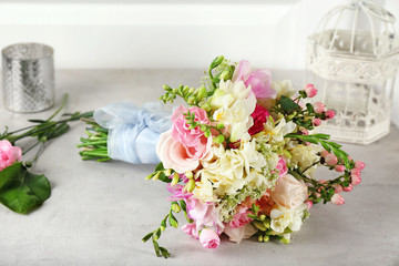 Beautiful bouquet with freesia flowers on table