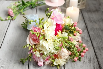 Beautiful bouquet with freesia flowers on table
