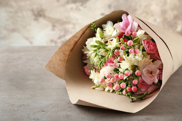 Fototapeta premium Beautiful bouquet with freesia flowers on table