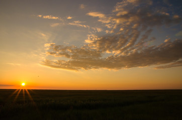Naklejka na ściany i meble starburst sunrise sunset with blue sky clouds over a marsh