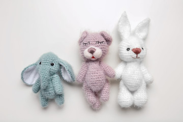 Handmade knitted baby toys isolated on white