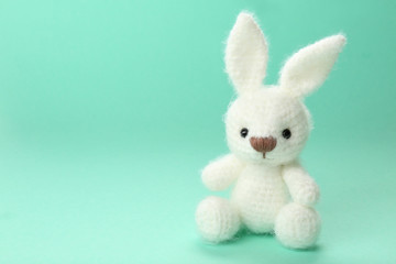 Cute handmade bunny toy on color background, closeup