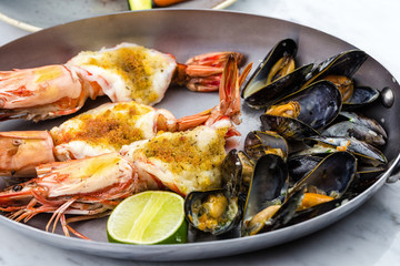 Royal prawns and mussel served in metal bowl