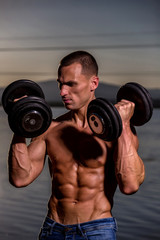 fitness muscular male model with weights