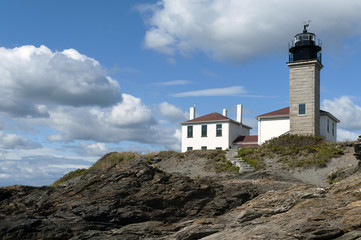 Fototapeta na wymiar Historic Beavertail Lighthouse with its Colonial architecture built over unique rocky shore in Rhode Island