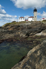 Fototapeta na wymiar Beavertail lighthouse sits atop unique rock formations in Rhode Island