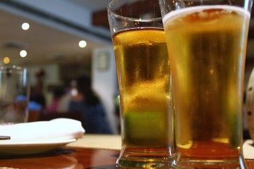 Two chilled full beer glasses