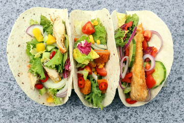 Delicious fish tacos on table