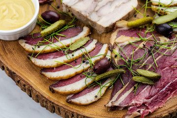 Cold smoked meat plate with, proscius on white wooden desk.