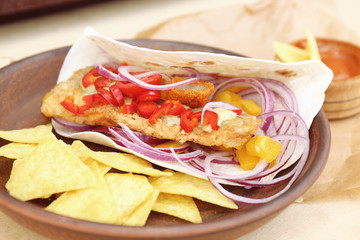 Plate with fish taco and chips, closeup