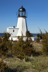 Fototapeta na wymiar Prudence Island lighthouse on a sunny day in Rhode island.
