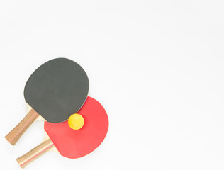 Sport background. Red and black ping-pong rackets and balls. Flat lay, top view.